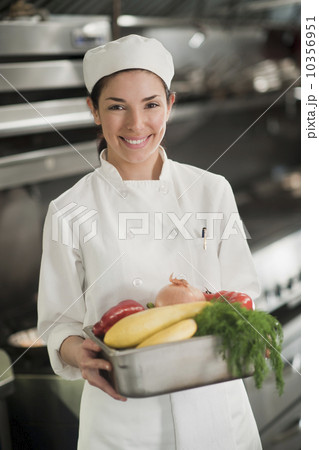 Smiling chef holding fresh vegetables 10356951