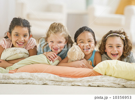 Portrait of girls (6-9) relaxing on pillows 10356953