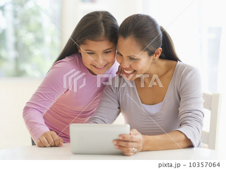 Mother and daughter (10-11) using digital tablet Mother and daughter (10-11) using digital tablet 10357064