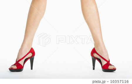 Low section of woman wearing red shoes on white background 10357116