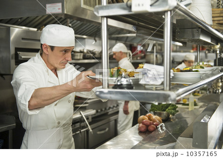 Chefs preparing food in kitchen 10357165