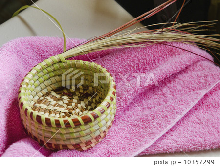 USA, South Carolina, Charleston, Close up of sweetgrass basket on towel 10357299