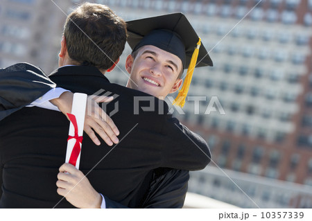 Father with teenage sun (16-17) at graduation ceremony Father with teenage sun (16-17) at graduation ceremony 10357339