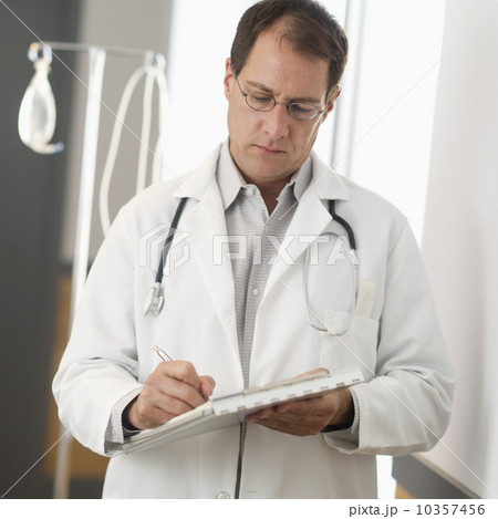 Doctor writing in clipboard Doctor writing in clipboard 10357456