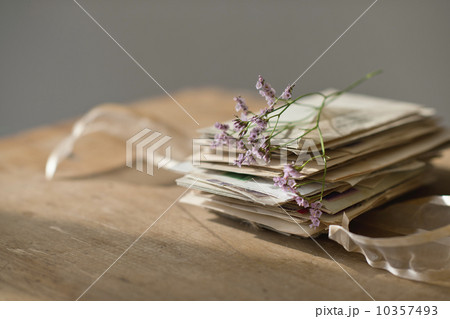 Lavender stem on stack of letters Lavender stem on stack of letters 10357493