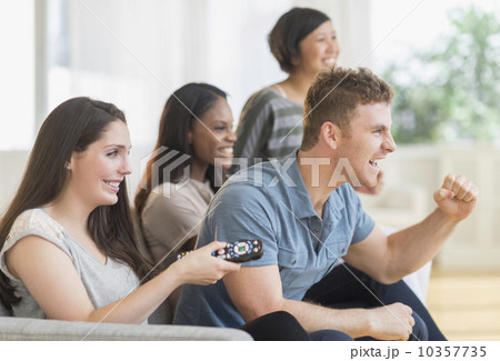 Friends watching tv on sofa 10357735