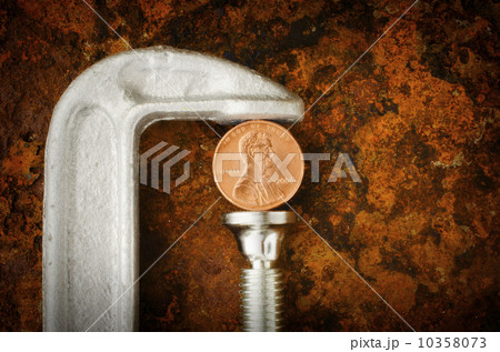 Studio shot of coin in vise grip 10358073