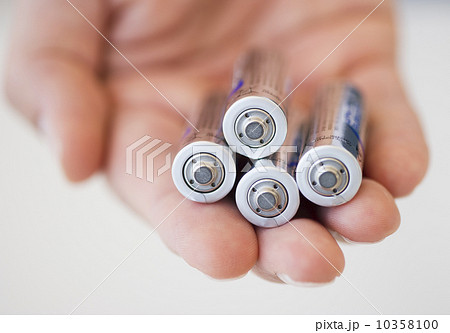 Hand holding batteries 10358100