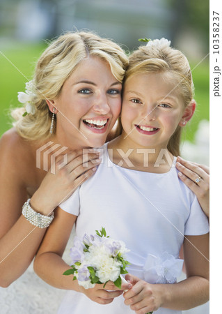 Portrait of bride with flower girl (10-11) at wedding reception 10358237