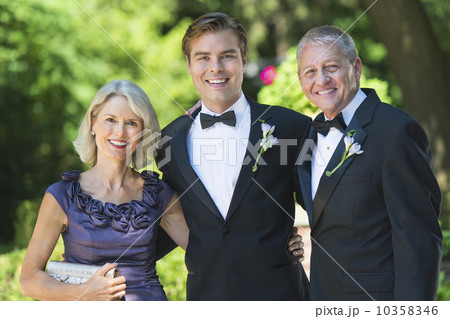 Portrait bridegroom with parents at wedding 10358346