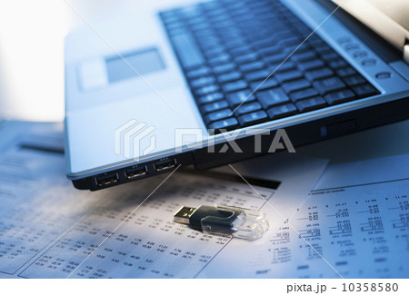 Studio shot of laptop with memory stick Studio shot of laptop with memory stick 10358580