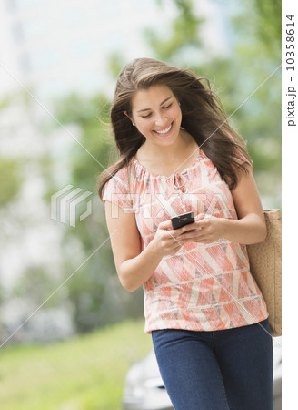 Woman texting on phone Woman texting on phone 10358614