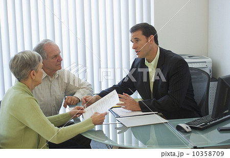 Senior couple talking to man in office Senior couple talking to man in office 10358709