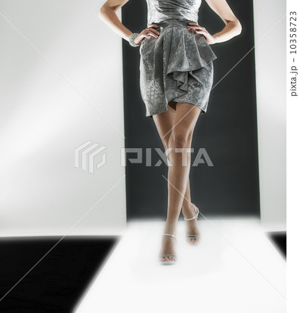 Female fashion model wearing dress on catwalk 10358723