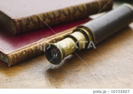 Close up of antique books and telescope Close up of antique books and telescope 10358807