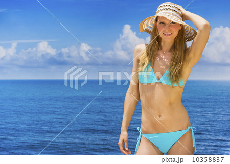 Woman wearing bikini by sea Woman wearing bikini by sea 10358837
