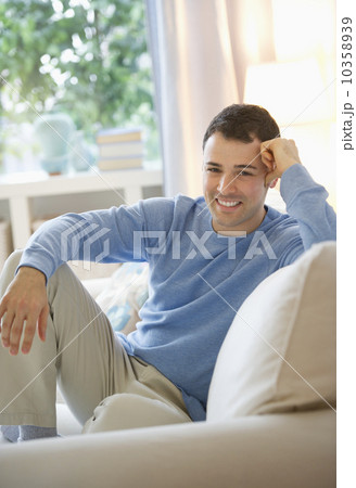 Man relaxing on sofa 10358939