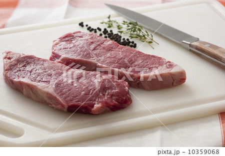 Studio shot of raw steak on chopping board Studio shot of raw steak on chopping board 10359068