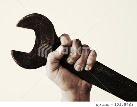 Hand holding wrench, studio shot Hand holding wrench, studio shot 10359438