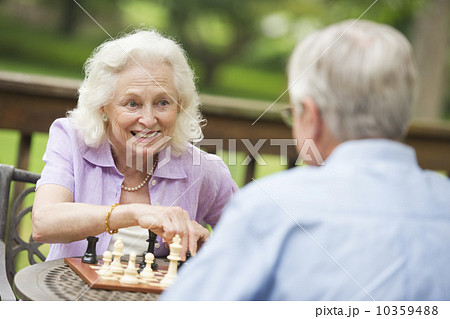 Seniors playing chess on porch Seniors playing chess on porch 10359488