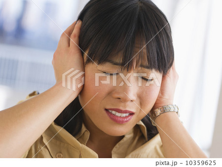 Woman covering ears 10359625