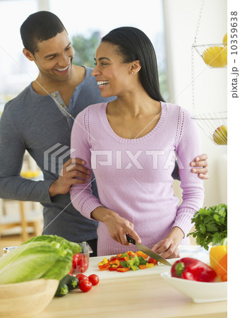 Couple chopping vegetables in kitchen Couple chopping vegetables in kitchen 10359638