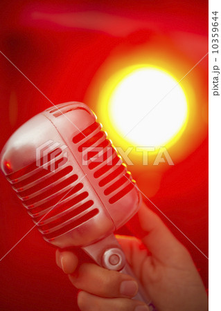 Hand holding microphone Hand holding microphone 10359644