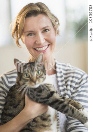 Portrait of woman holding cat 10359708