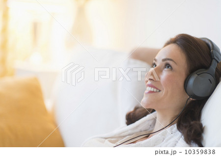 Woman listening to music at home Woman listening to music at home 10359838