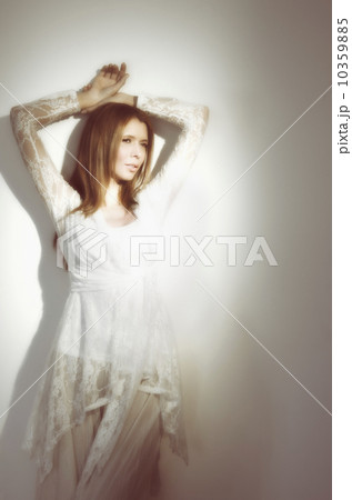 Woman relaxing against wall Woman relaxing against wall 10359885