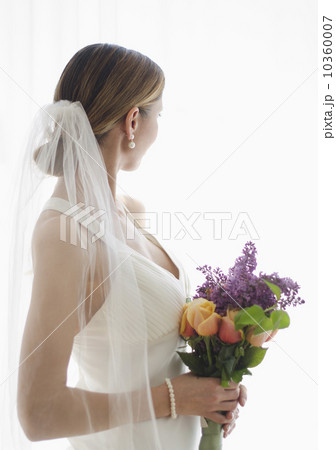 Bride holding floral bouquet Bride holding floral bouquet 10360007