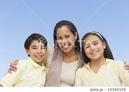 Portrait of mother with son (12-13) and daughter (10-11)  10360109