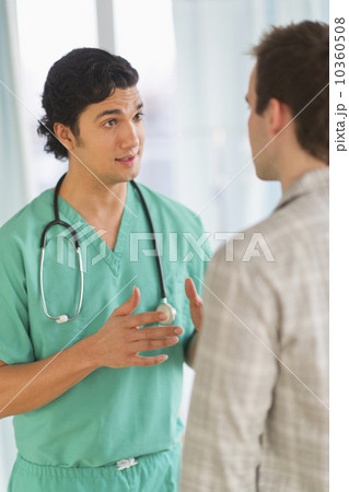 Male doctor talking to male patient in hospital 10360508
