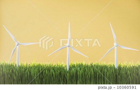 Model wind turbines in grass on yellow background Model wind turbines in grass on yellow background 10360591