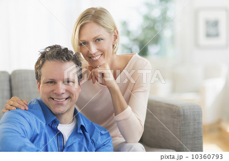 Portrait of couple sitting on sofa 10360793