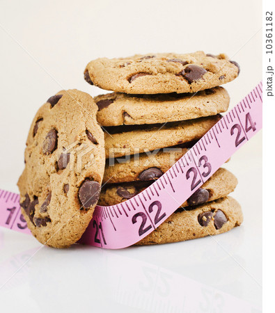 Stack of chocolate chip cookies with measure tape 10361182