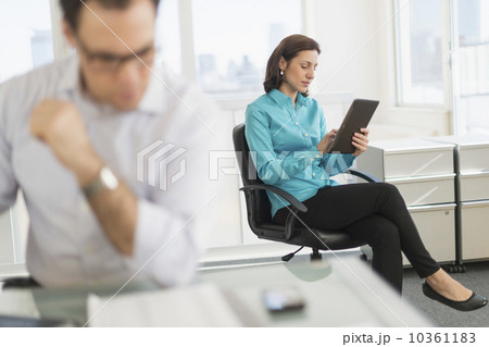 Businessman and businesswoman working in office 10361183