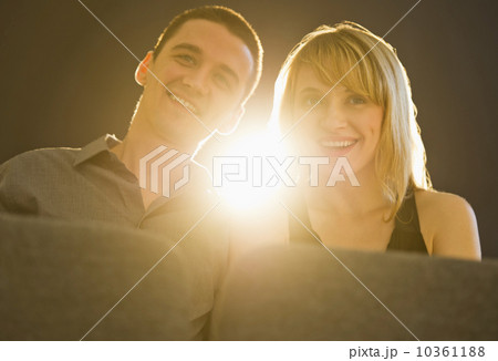 Couple in cinema with light behind 10361188