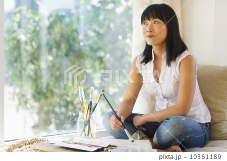 Mid adult woman painting at home 10361189
