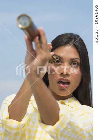 Woman looking through telescope Woman looking through telescope 10361405