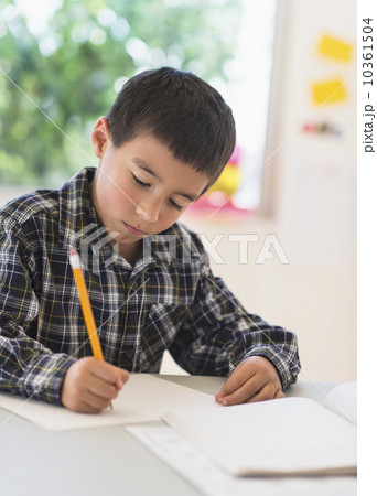 Boy (6-7) writing at school Boy (6-7) writing at school 10361504