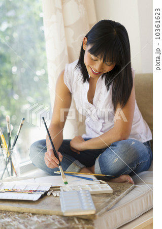 Mid adult woman painting at home 10361623