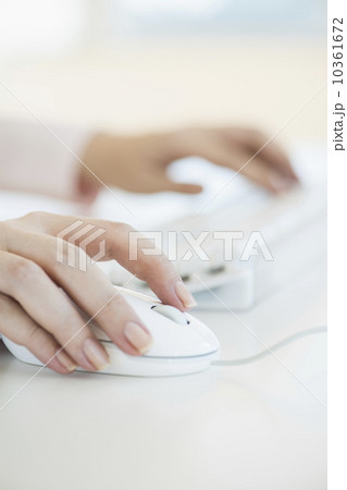Close up of woman's hands using computer keyboard and computer mouse Close up of woman's hands using computer keyboard and computer mouse 10361672