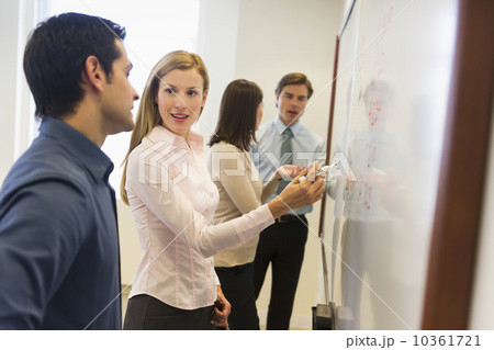 Business people writing at whiteboard 10361721