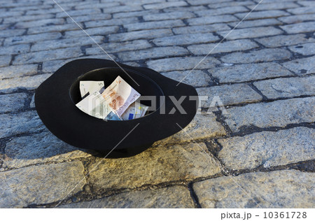 Money in hat on cobblestone street Money in hat on cobblestone street 10361728