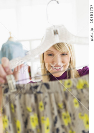 Woman looking at skirt in clothes store 10361757
