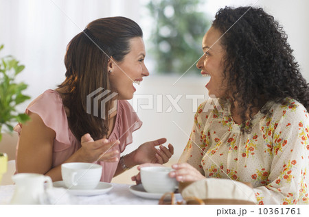 Two women chatting at cafe table 10361761
