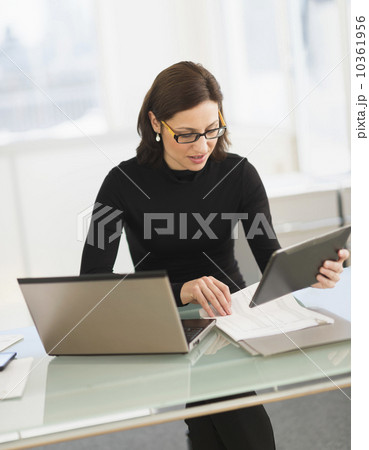 Businesswoman working on laptop and digital tablet 10361956