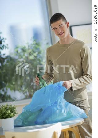 Teenager (16-17) recycling bottles 10362039