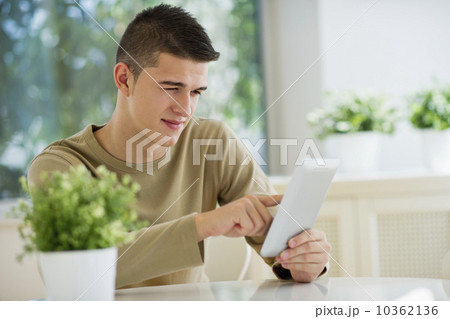 Teenager (16-17) using digital tablet 10362136